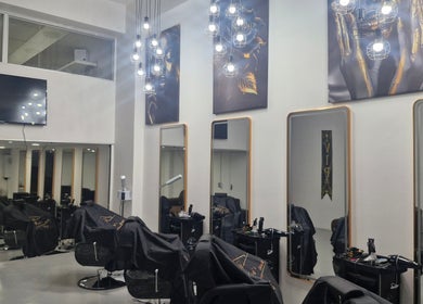 Modern interior of Kings Blade Barbershop in Randburg, Gauteng, ZA, featuring stylish chairs and mirrors.