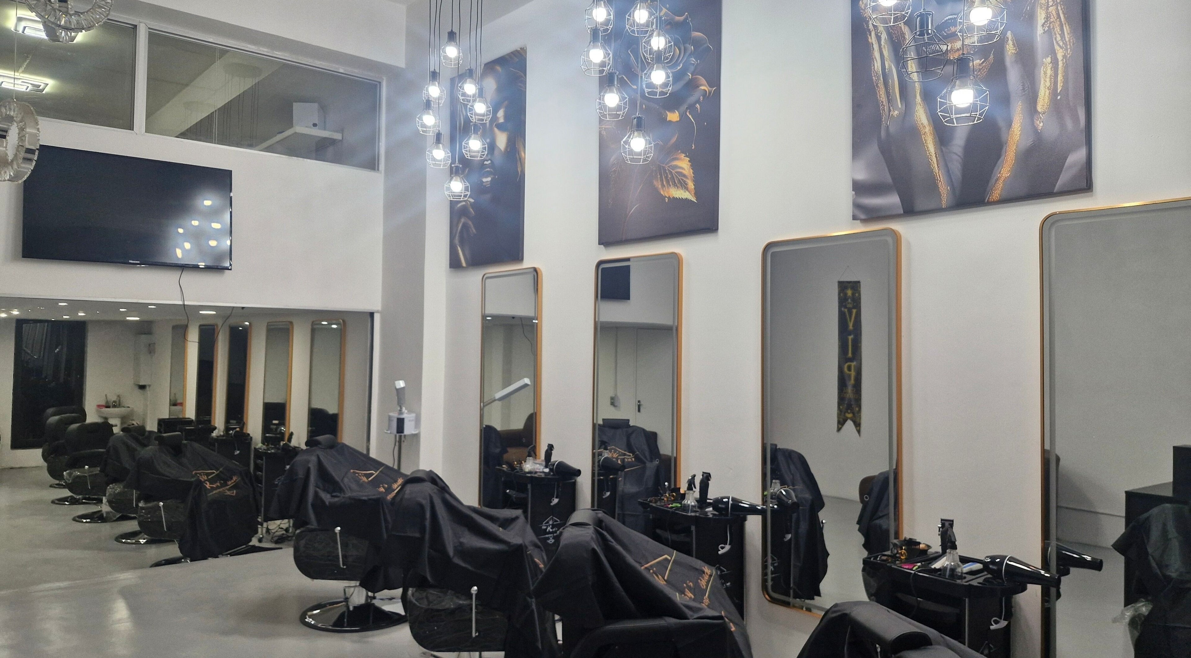 Modern interior of Kings Blade Barbershop in Randburg, Gauteng, ZA, featuring stylish chairs and mirrors.