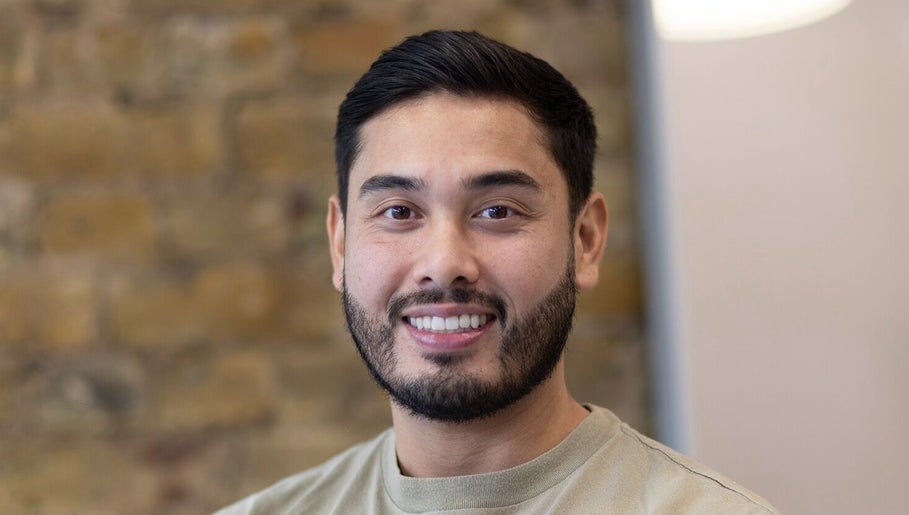 Friendly barber at Barber Nick.LS, Twickenham, England, GB, showcasing welcoming ambiance.