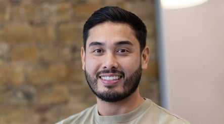 Friendly barber at Barber Nick.LS, Twickenham, England, GB, showcasing welcoming ambiance.