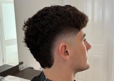 Side view of a stylish fade haircut at Barber Nick.LS, Twickenham, England, GB.