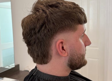 Stylish male haircut at Barber Nick.LS in Twickenham, England, GB. Showcasing expert grooming techniques.
