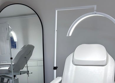 Modern treatment chair and mirror at LR_Aesthetics, Barry, Wales, GB. Sleek and inviting wellness space.