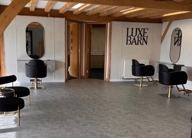 Chic and modern salon interior at AlexandraJaine Extensions, Tickenham, England, GB. Stylish seating and mirrors.