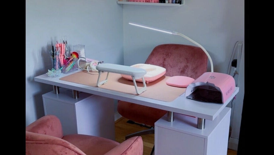 Elegant nail station at Glitterland Nails, London, England, GB, featuring tools and plush seating.