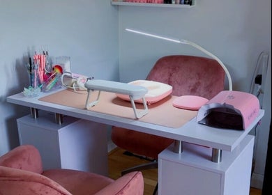 Elegant nail station at Glitterland Nails, London, England, GB, featuring tools and plush seating.