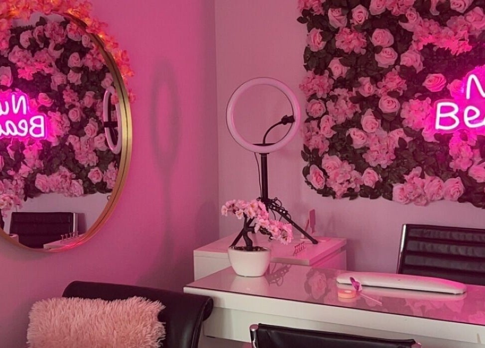 Nuabeauty interior with pink rose decor and neon sign in Bradford, England, GB.