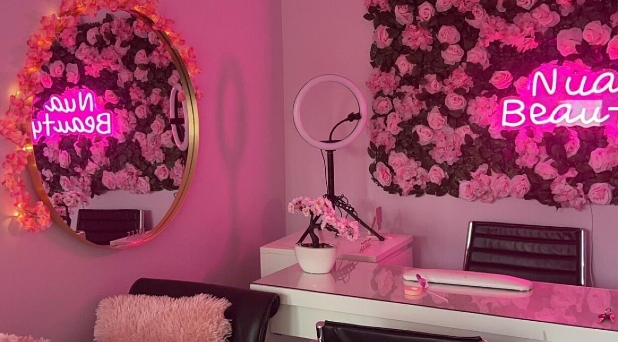 Nuabeauty interior with pink rose decor and neon sign in Bradford, England, GB.
