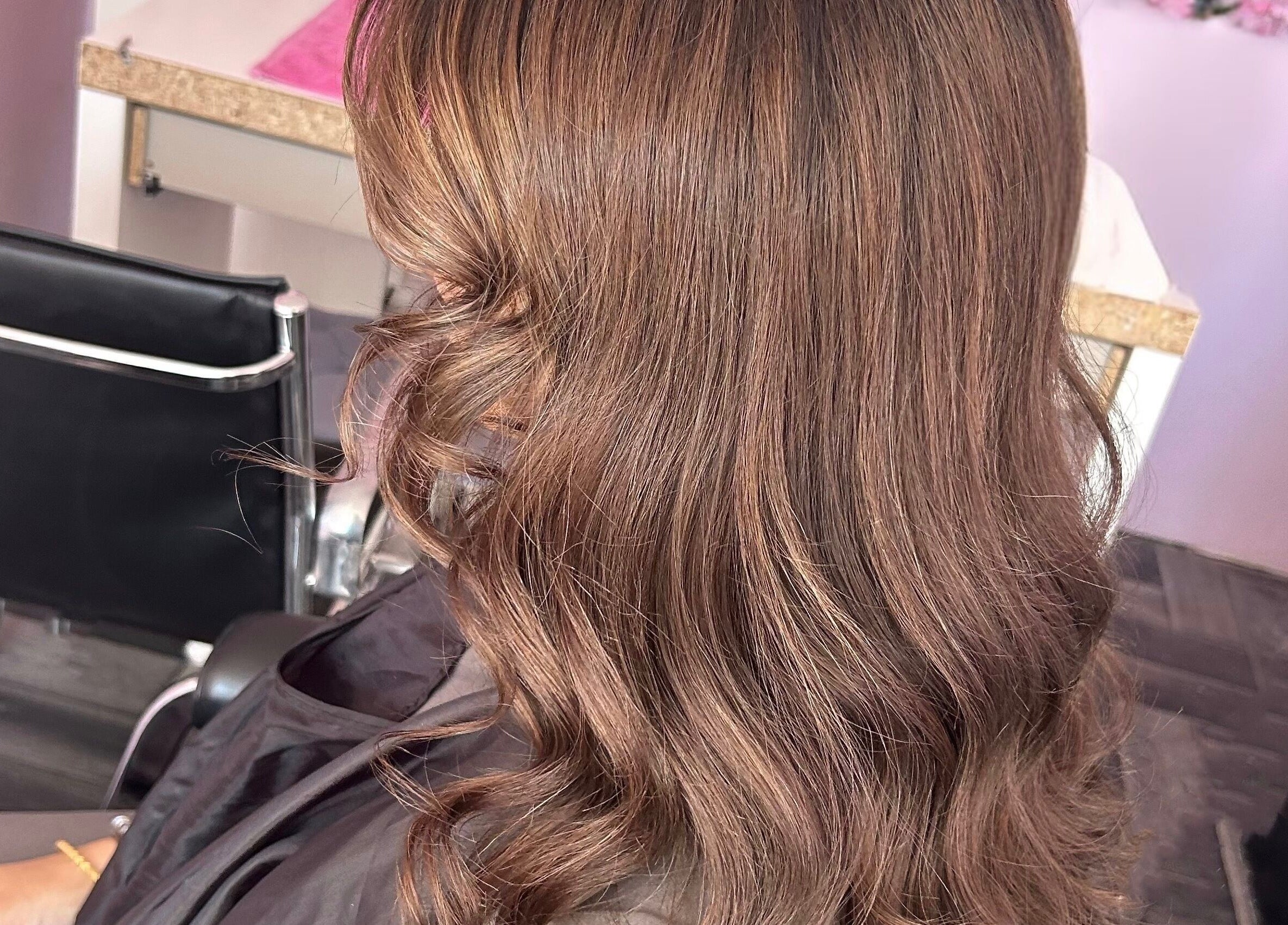 Wavy brown hair styled at Nuabeauty, Bradford, England, GB, showcasing chic salon interior.