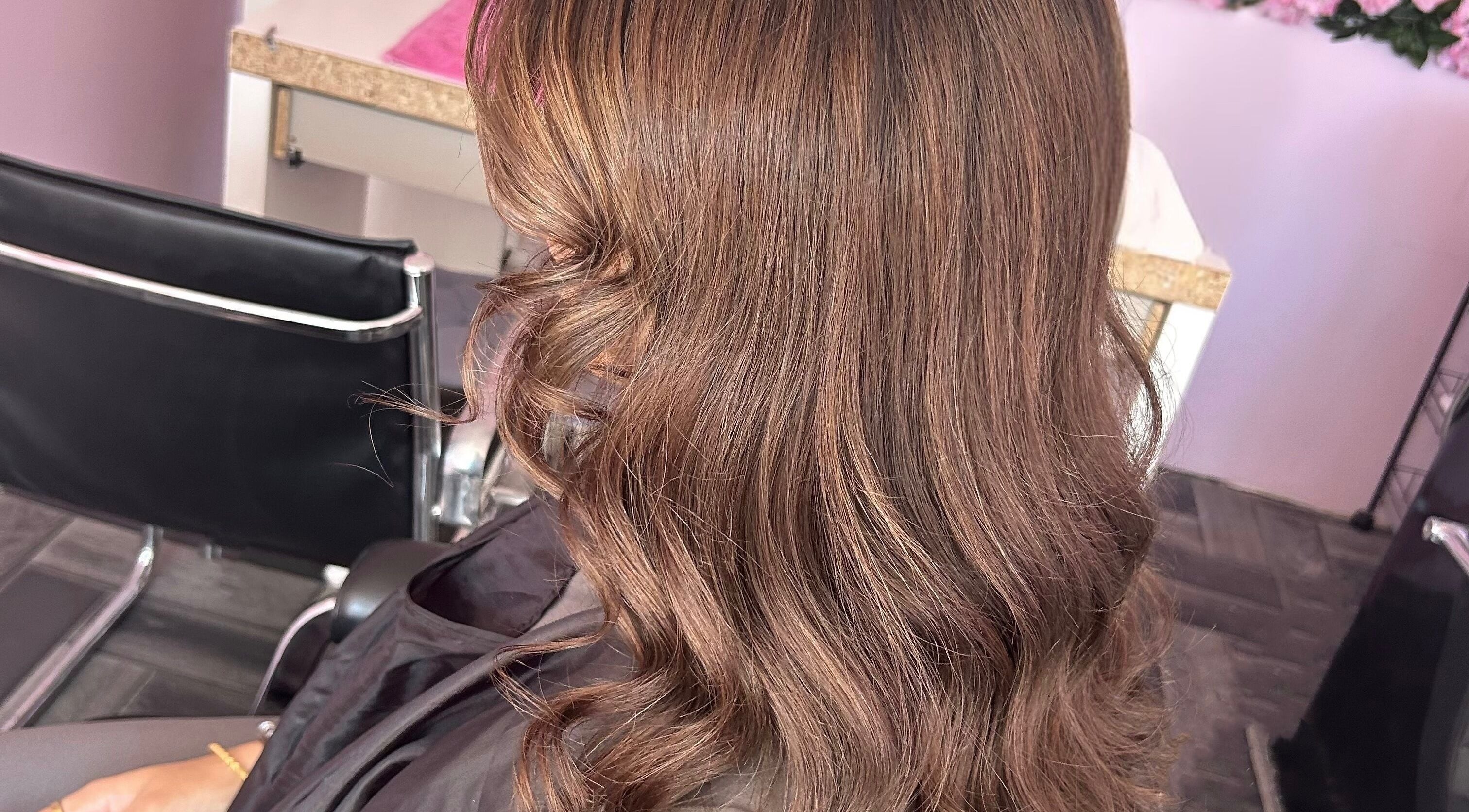 Wavy brown hair styled at Nuabeauty, Bradford, England, GB, showcasing chic salon interior.