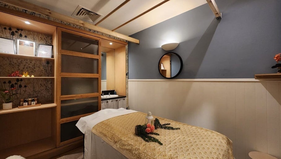 Tranquil massage room at Thai Wellbeing Massage, Maidstone, England, GB with a treatment table and decor.