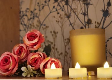 Candlelit roses at Thai Wellbeing Massage, Maidstone, England, GB, create a tranquil ambiance.
