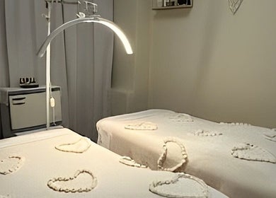 Tranquil massage suite at Body Rituals Spa, Calgary, Alberta, CA with soft lighting and heart-shaped towel designs.