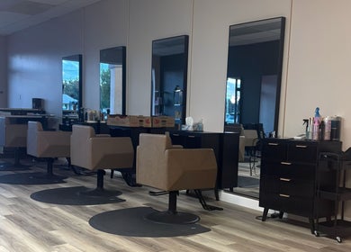 Salon interior at Locks By Liv, St. Catharines, Ontario, CA with modern styling chairs and mirrors.