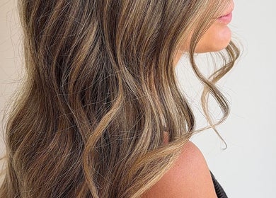 Elegant wavy hair styled fabulously at Locks By Liv in St. Catharines, Ontario, CA, showcasing beautiful highlights.