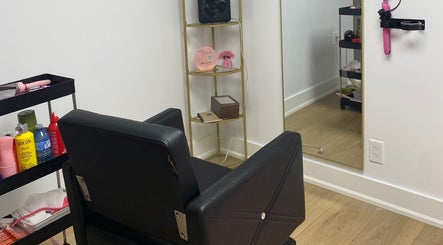 Hair styling station at Paradise Glamour Lounge INC., St. Catharines, Ontario, CA, featuring modern salon chair.
