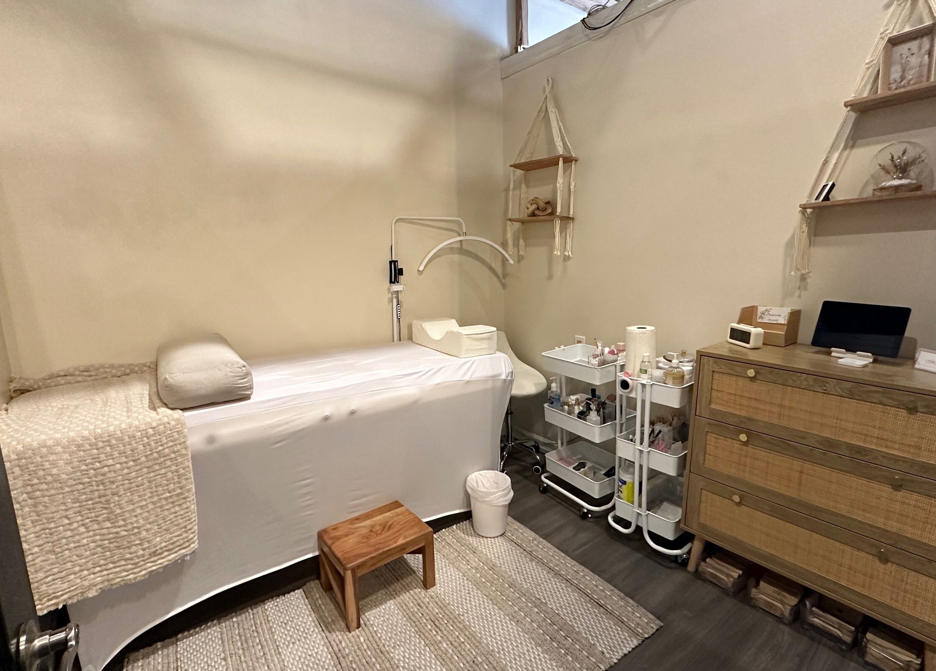 Tranquil treatment room at Madly In Lashed in Hamilton, Ontario, CA with a cozy bed and natural decor.