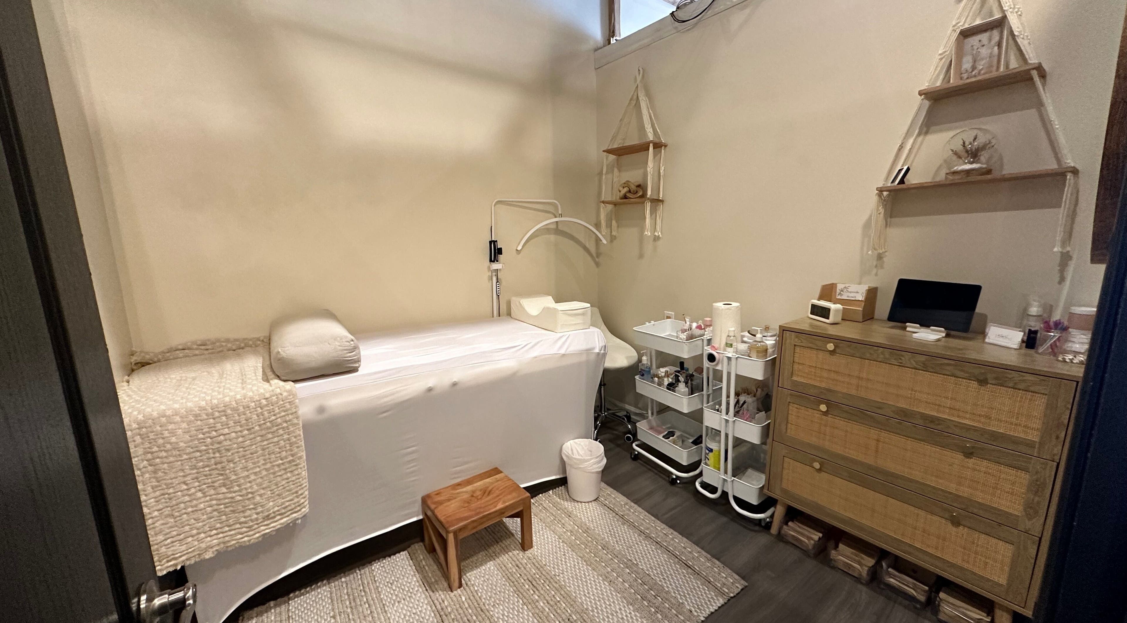 Tranquil treatment room at Madly In Lashed in Hamilton, Ontario, CA with a cozy bed and natural decor.