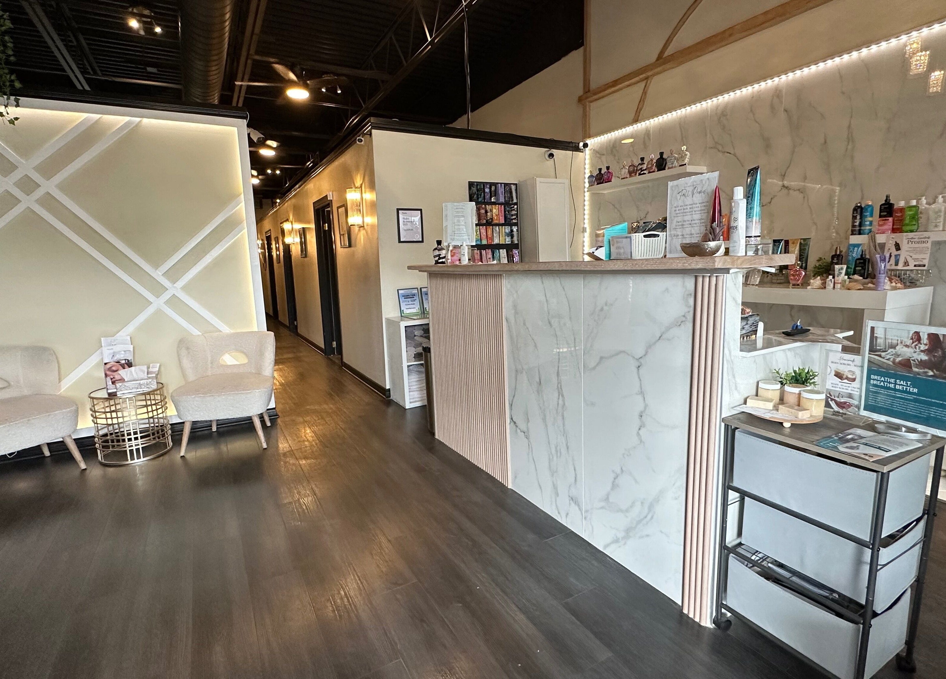 Elegant reception area at Madly In Lashed, Hamilton, Ontario, CA with seating and product display.