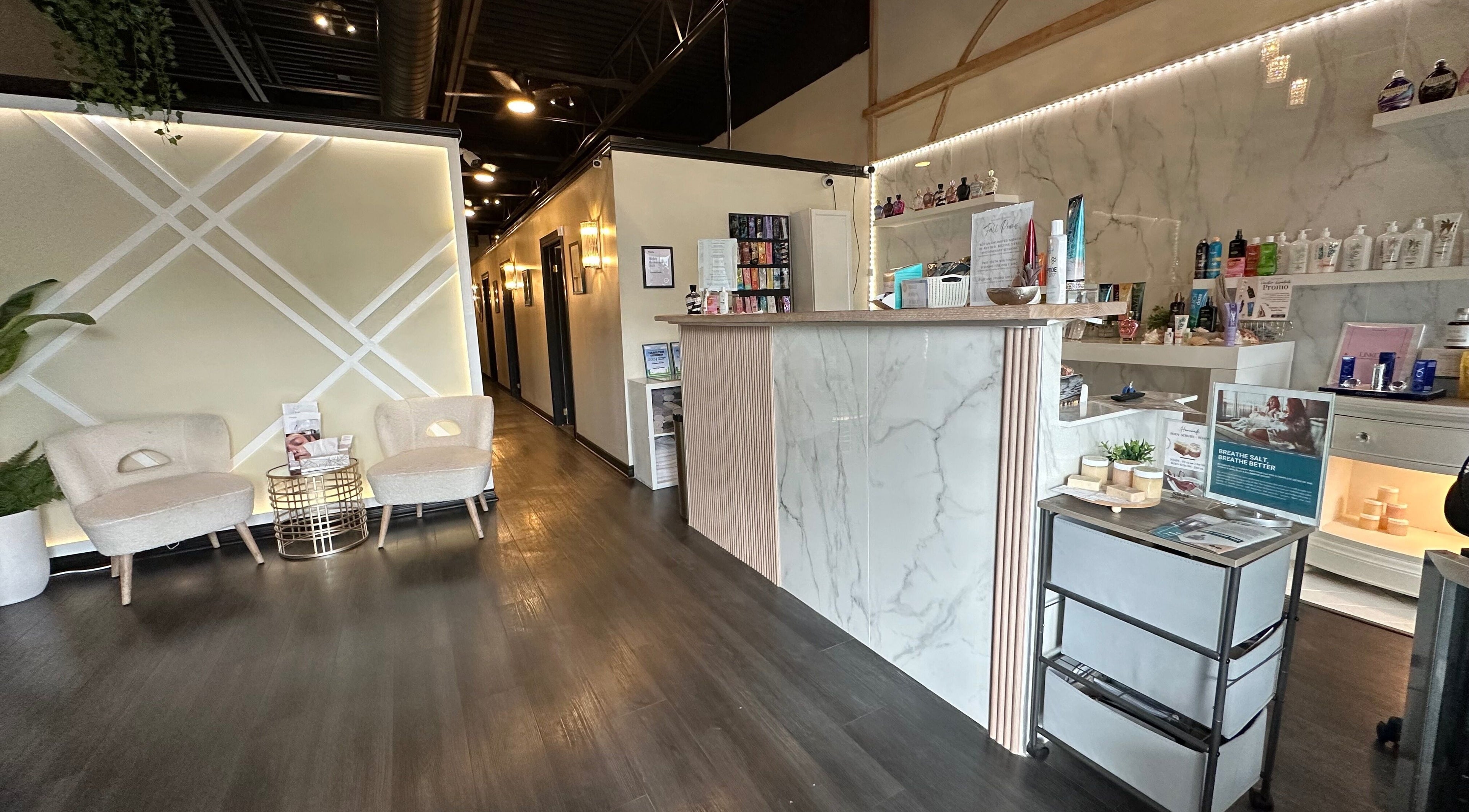 Elegant reception area at Madly In Lashed, Hamilton, Ontario, CA with seating and product display.