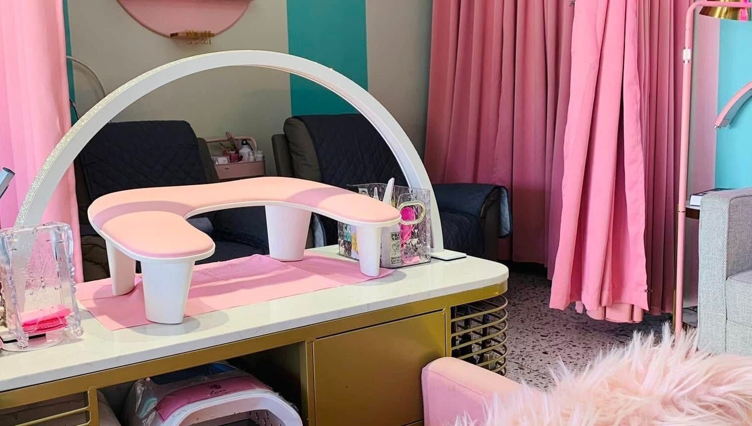 Chic nail station at All Glammed Up in Cebu City, Central Visayas, PH, featuring pink decor and plush seating.