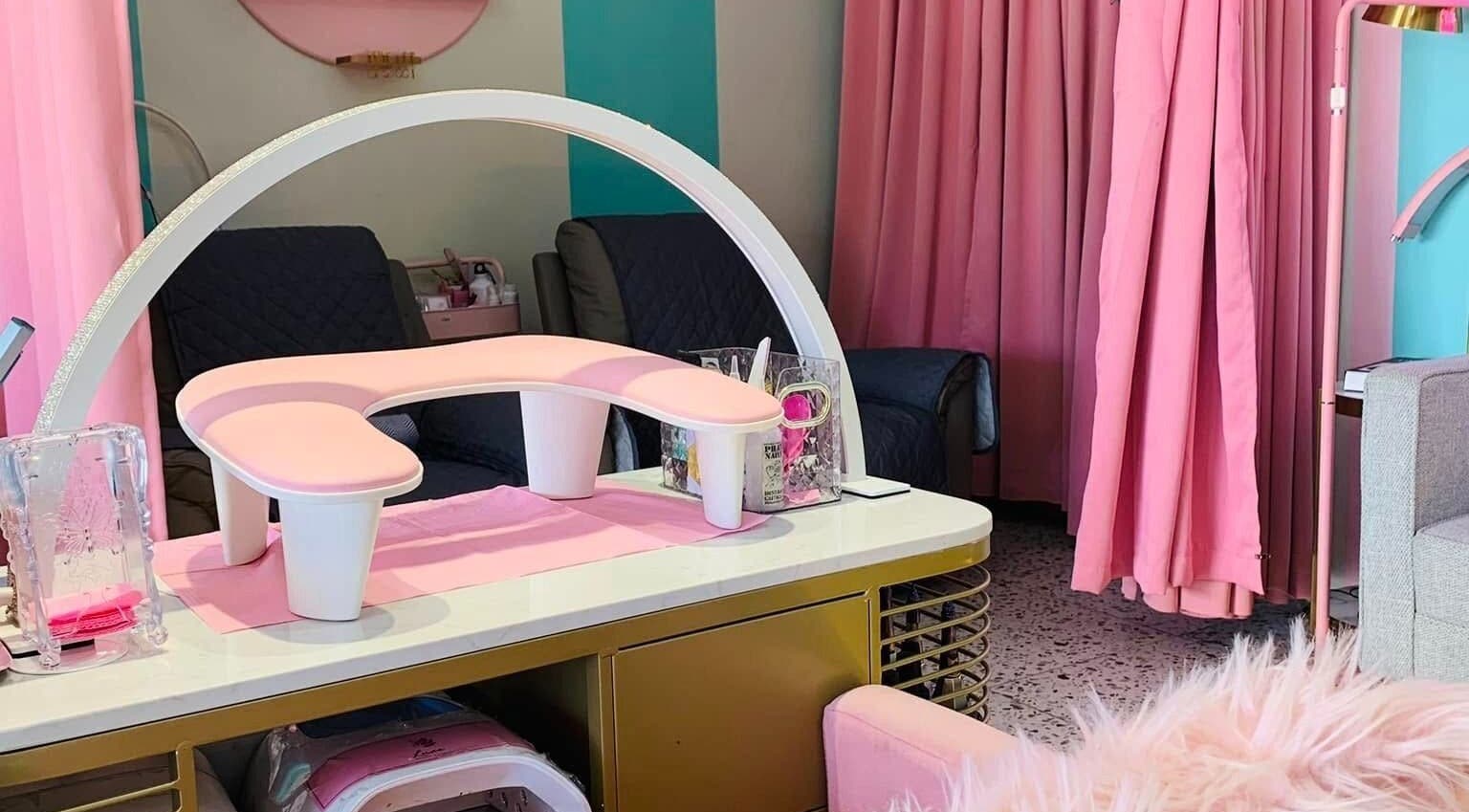 Chic nail station at All Glammed Up in Cebu City, Central Visayas, PH, featuring pink decor and plush seating.
