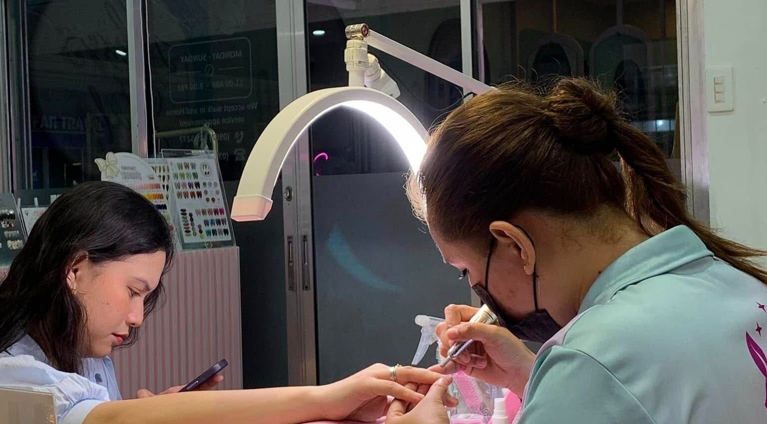 Nail technician crafting intricate designs at All Glammed Up, Cebu City, Central Visayas, PH.