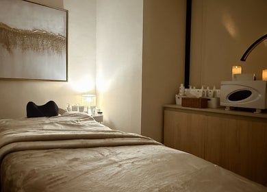 Relaxing treatment room at Lish Hair & Beauty - JBR, Dubai, AE. Cozy bed and soft lighting for ultimate relaxation.