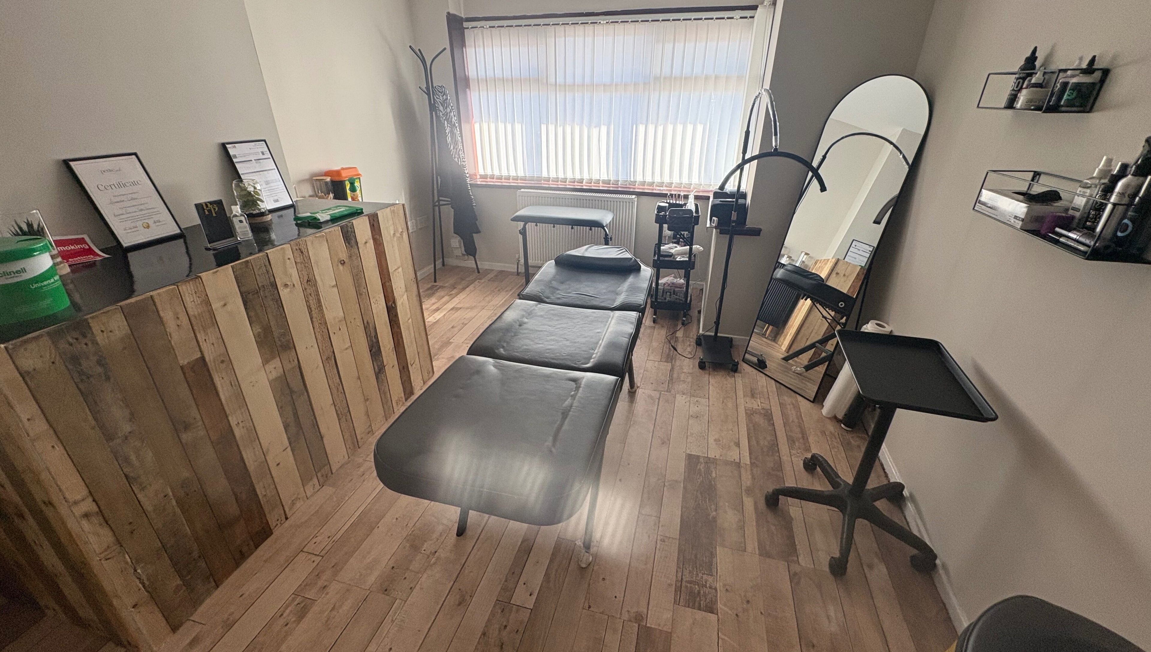 Pretty&Pain serene treatment room with bed and wooden decor in Willenhall, England, GB.