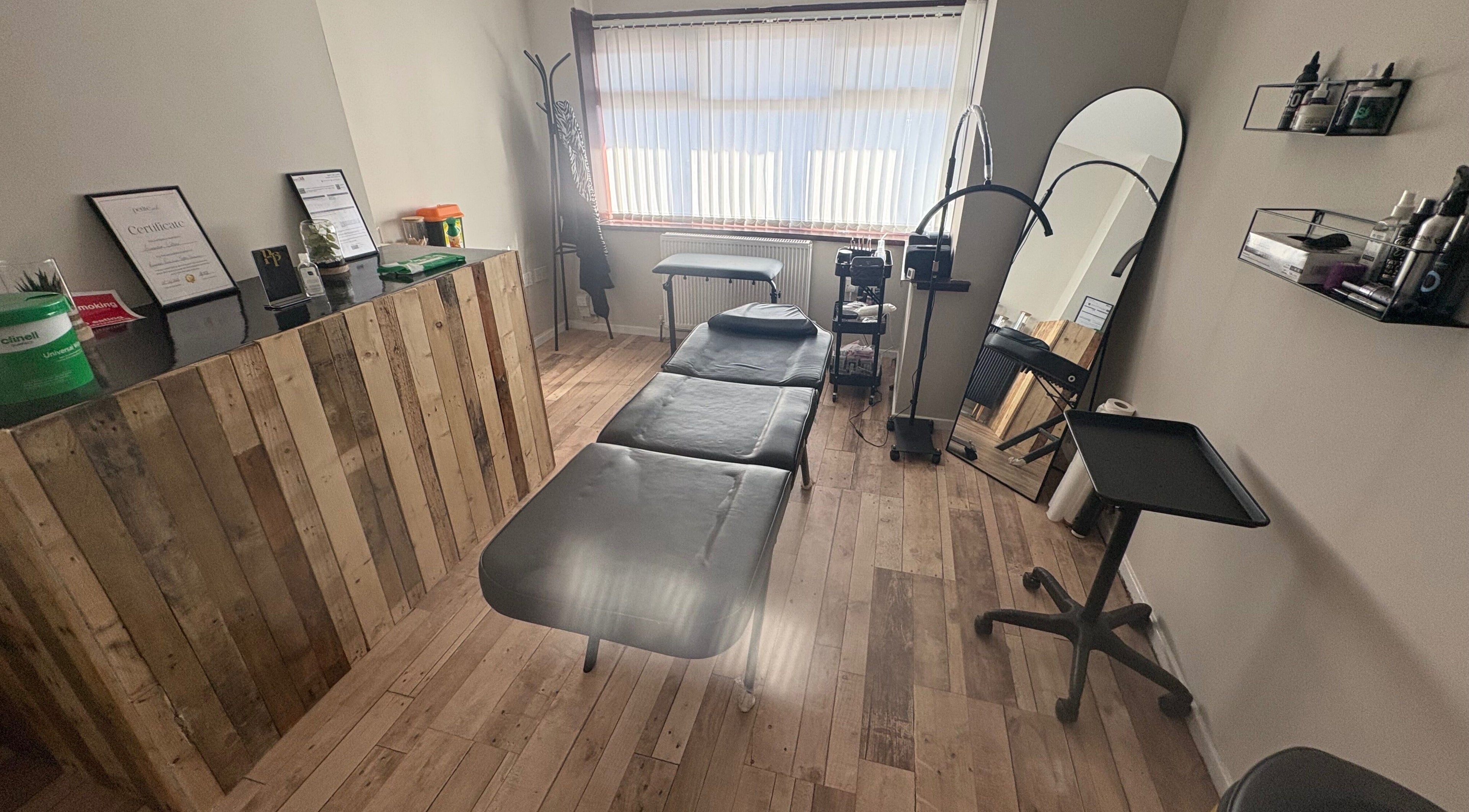 Pretty&Pain serene treatment room with bed and wooden decor in Willenhall, England, GB.