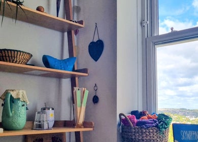 Shelf with decor in Ochroma Home Sauna, Brighton And Hove, England, GB. Calm atmosphere with a scenic view.