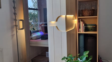 Modern home sauna at Ochroma home Sauna, Brighton And Hove, England, with books and relaxing ambiance.