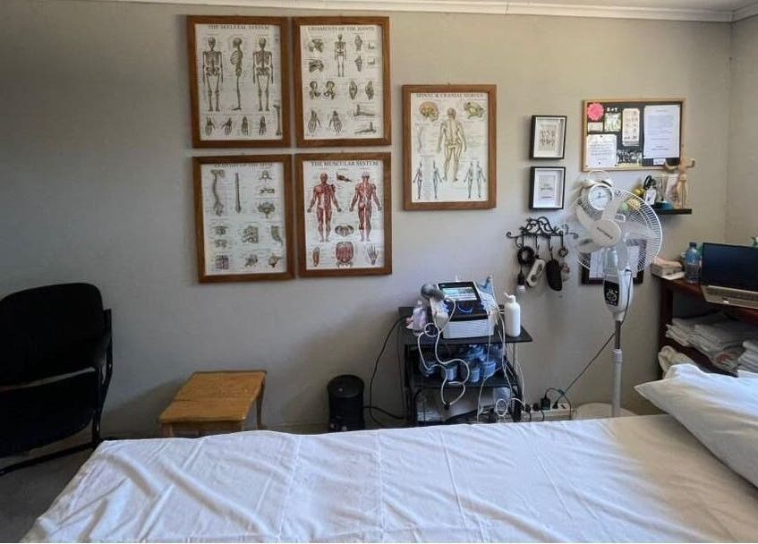 Therapeutic room at Dynamic Physical Therapy - Town Center, Lusaka, featuring anatomy charts and modern equipment.