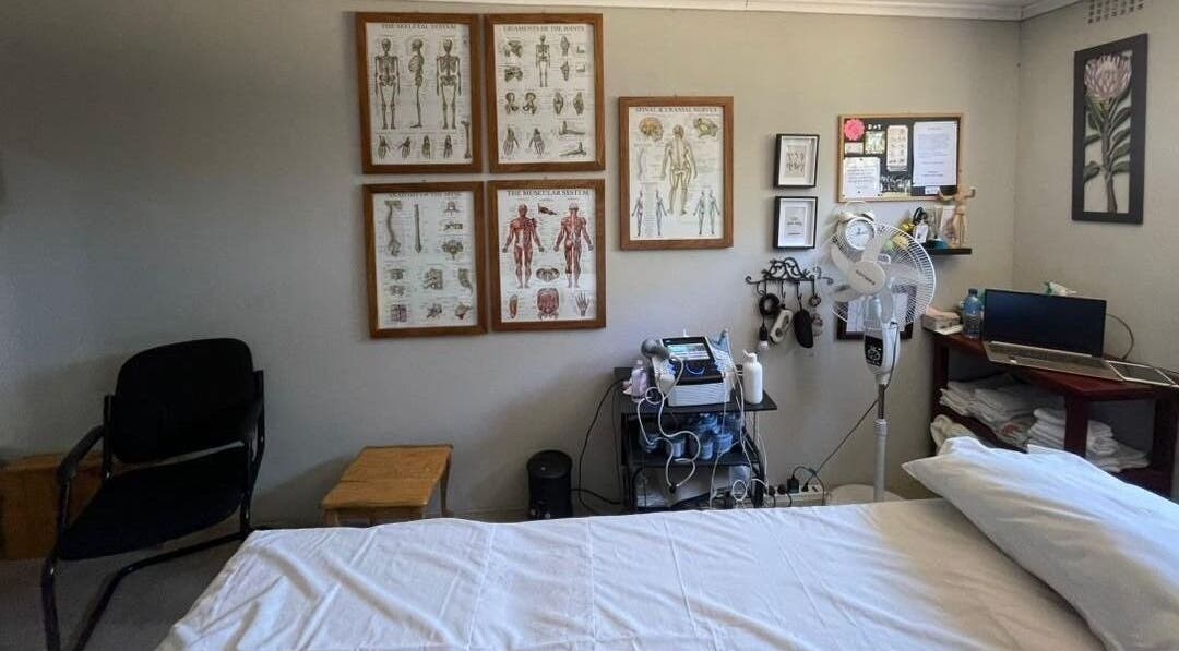 Therapeutic room at Dynamic Physical Therapy - Town Center, Lusaka, featuring anatomy charts and modern equipment.
