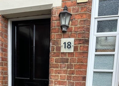 Welcoming entrance of Nails by Stacey, Newcastle-under-lyme, England featuring a classic brick facade.