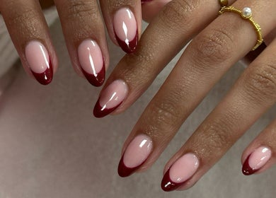 Elegant ruby-tipped nails by Nails by Stacey in Newcastle-under-lyme, England, GB. Perfect for stylish occasions.