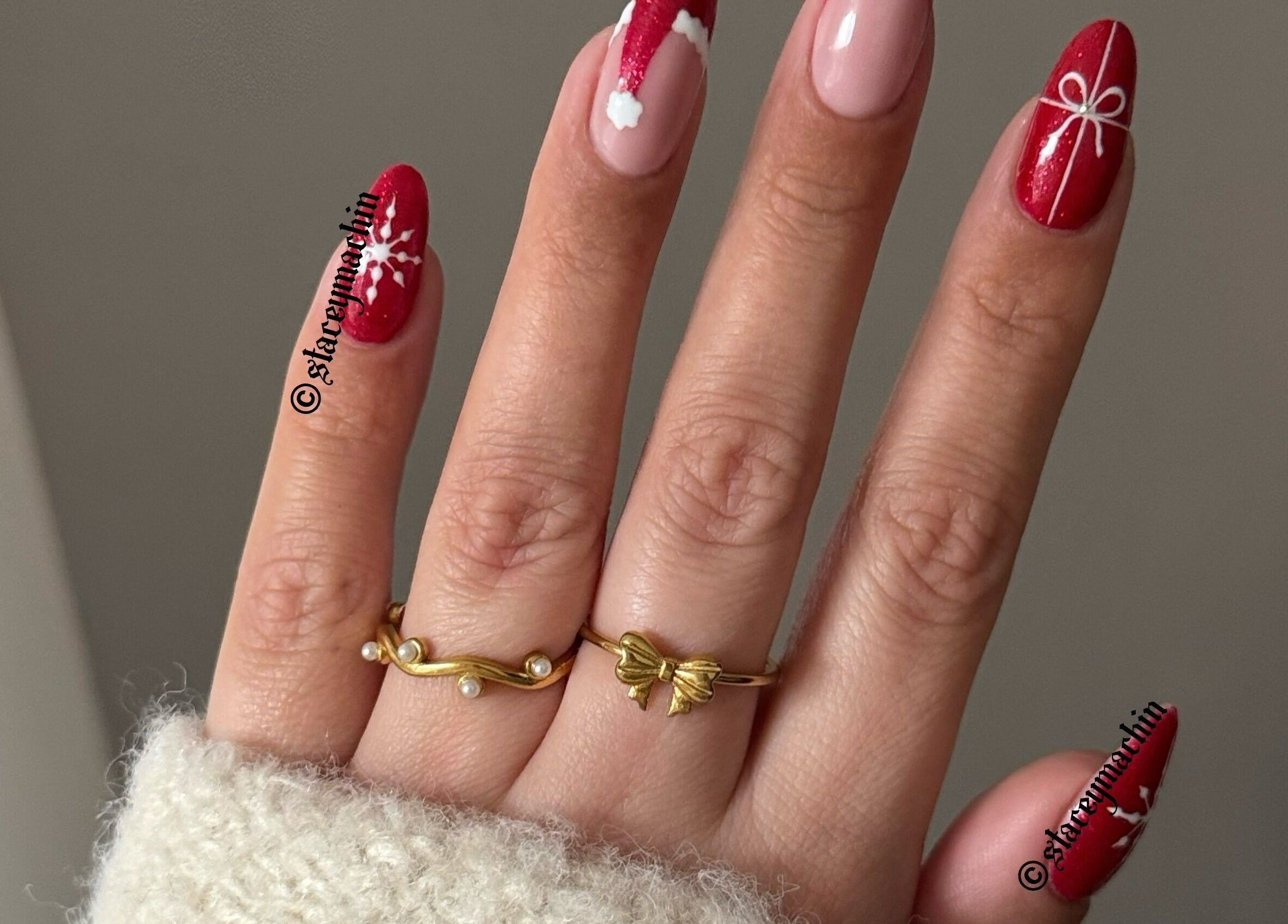 Christmas nail art by Nails by Stacey in Newcastle-under-lyme, England, GB. Red designs with snowflakes and bows.