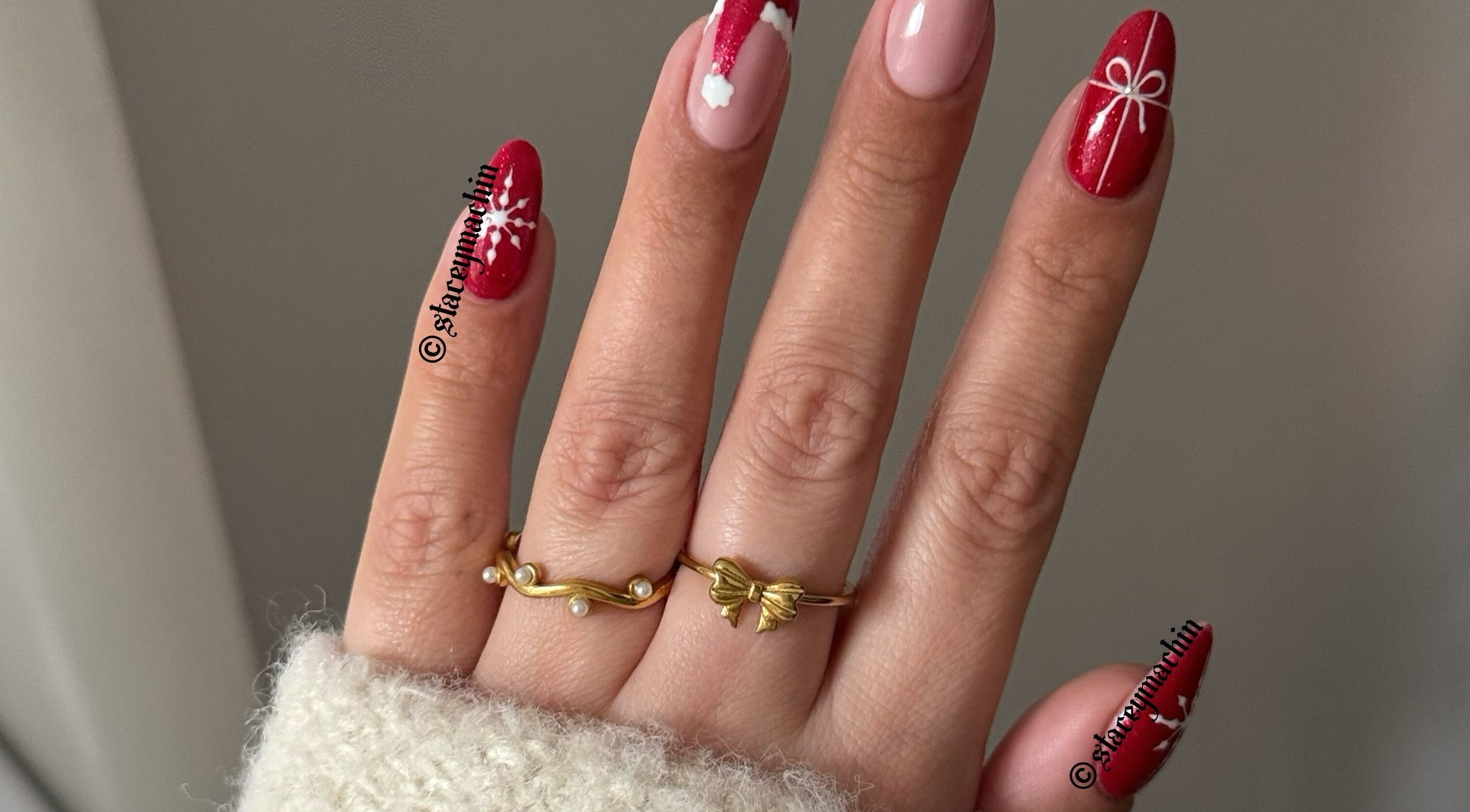 Christmas nail art by Nails by Stacey in Newcastle-under-lyme, England, GB. Red designs with snowflakes and bows.