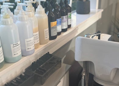 Shampoo bottles and basin at Hairlistic Hair Salon And Barbers in Kesgrave, England, GB.