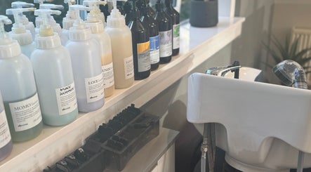 Shampoo bottles and basin at Hairlistic Hair Salon And Barbers in Kesgrave, England, GB.