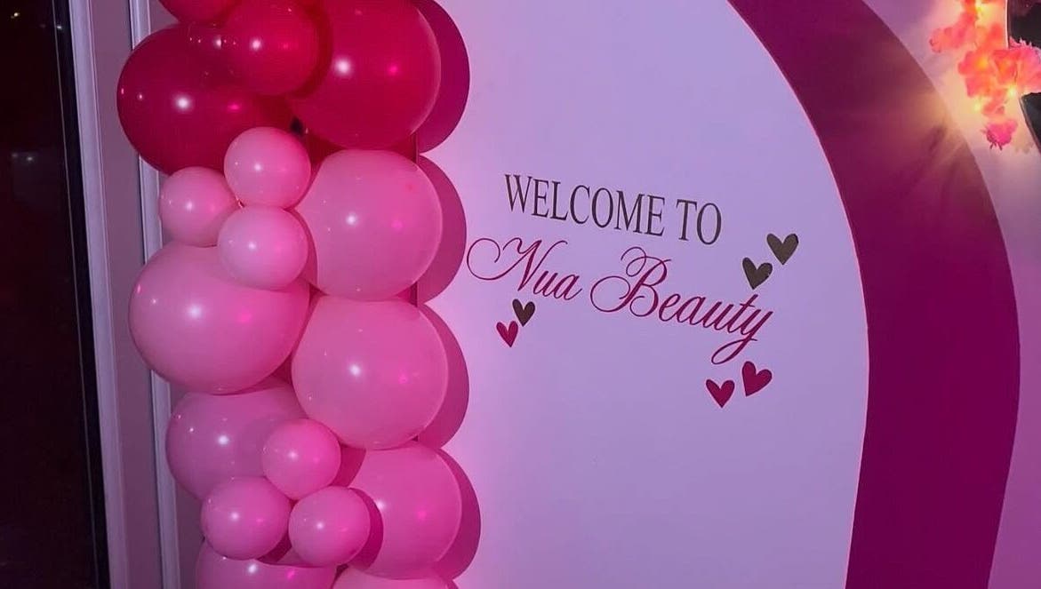 Welcome display with pink balloons at Nua Beauty, Bradford, England, GB.