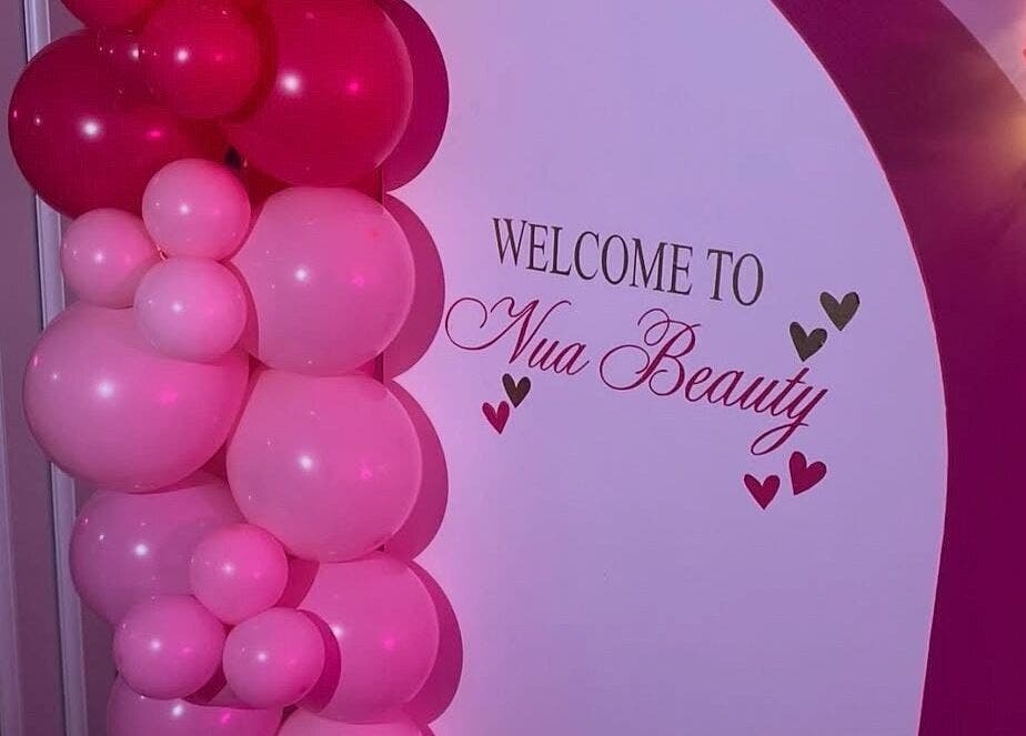 Welcome display with pink balloons at Nua Beauty, Bradford, England, GB.