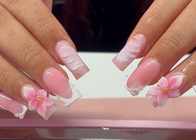 Floral acrylic nails at Nua Nails, Bradford, England, GB showcasing pink designs with delicate flowers.