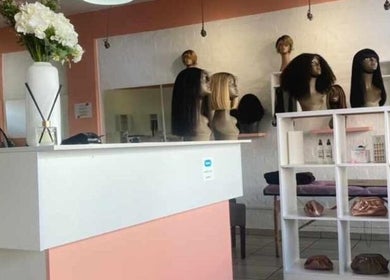 The Belle Boutique in Randburg, Gauteng, ZA showcasing stylish wig displays and chic interior decor.