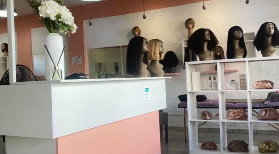 The Belle Boutique in Randburg, Gauteng, ZA showcasing stylish wig displays and chic interior decor.