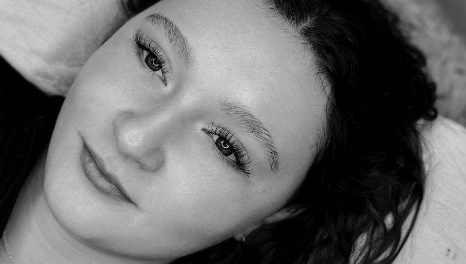 Close-up of a woman's face with long lashes at Carvedbyceri, Welshpool, Wales, GB.