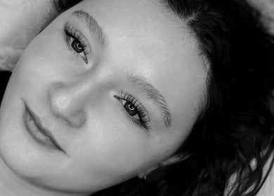 Close-up of a woman's face with long lashes at Carvedbyceri, Welshpool, Wales, GB.