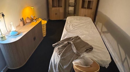 Relaxing treatment room at Clear Canvas Tattoo Removal, Peterhead, Scotland, GB, with cozy decor and ambient lighting.