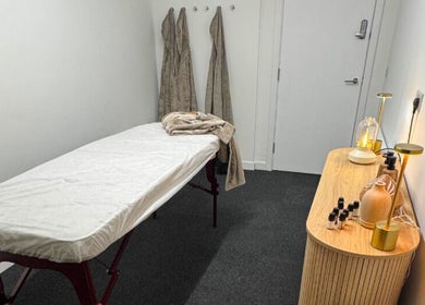 Calm treatment room at Clear Canvas Tattoo Removal, Peterhead, Scotland, GB, with massage table and ambient lighting.