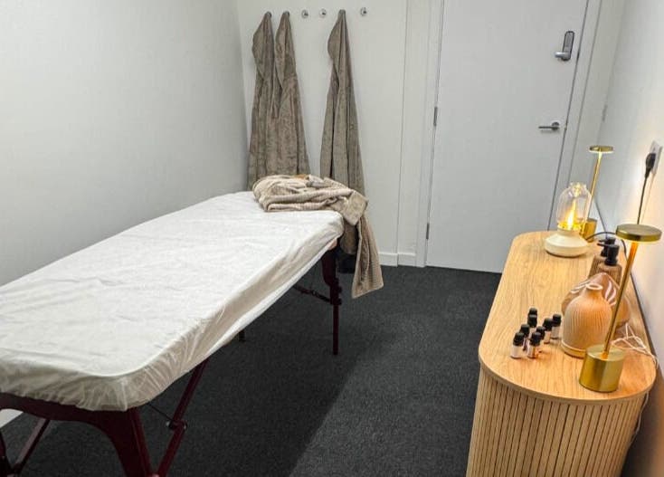 Calm treatment room at Clear Canvas Tattoo Removal, Peterhead, Scotland, GB, with massage table and ambient lighting.